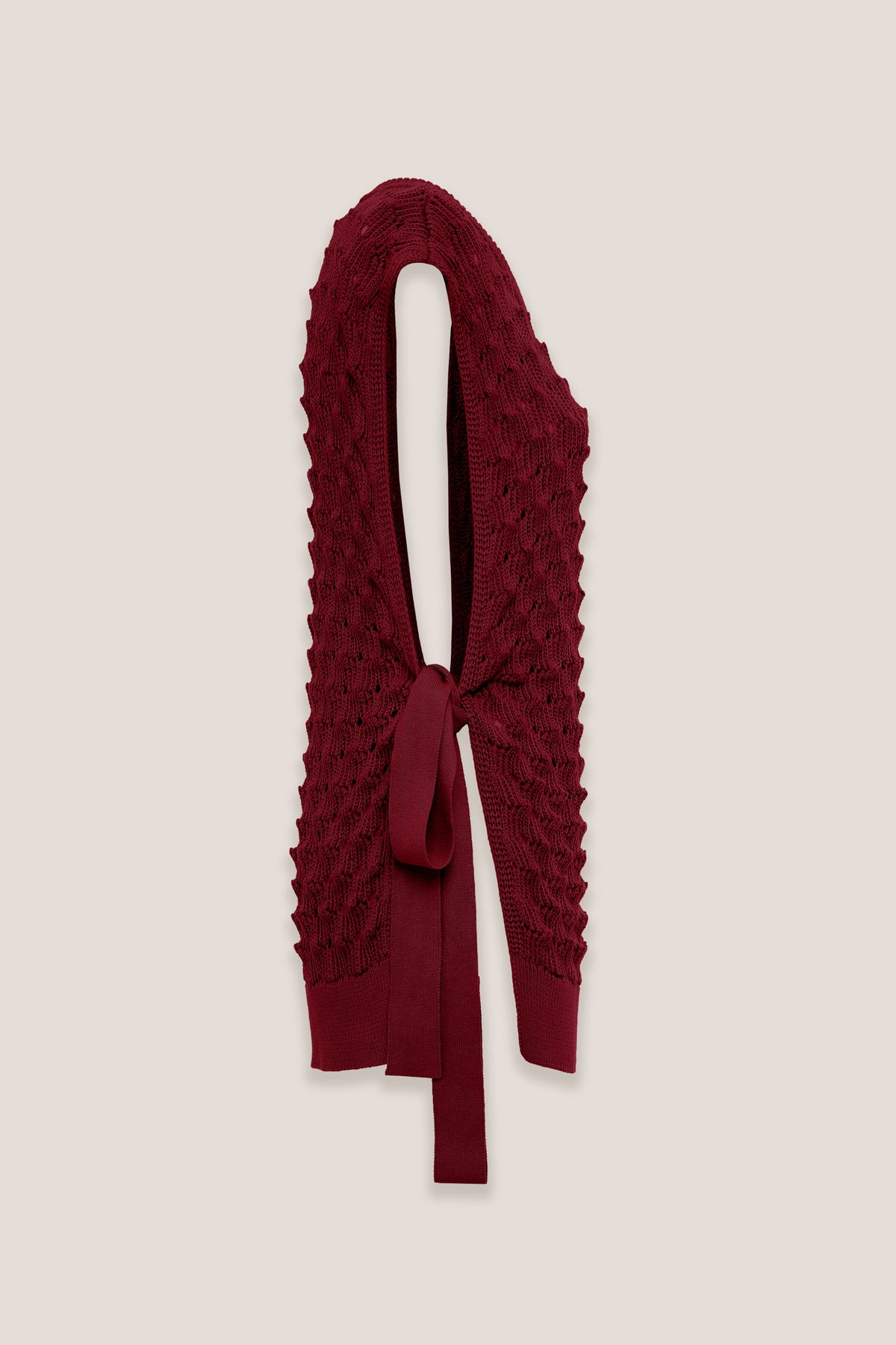 Amparo Fuoco openwork knit vest, side view, on a plain background